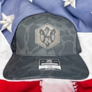 Camouflage cap on American flag background