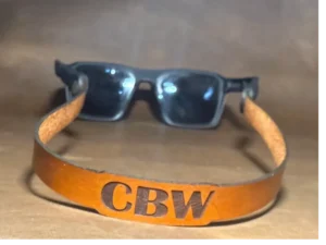 Black sunglasses on brown background