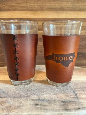 Two glasses with leather sleeves
